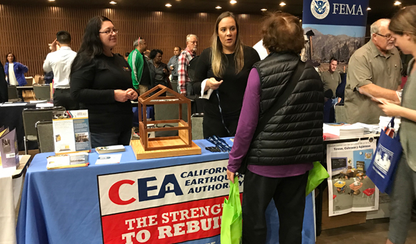 Image: CEA staff talking to a San Francisco resident about the importance of earthquake insurance and house retrofitting