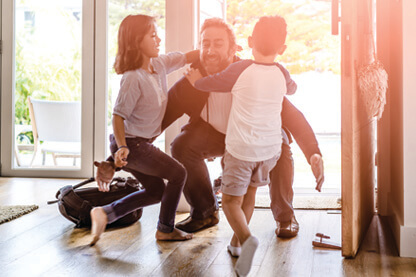 Image: Father hugging 2 children