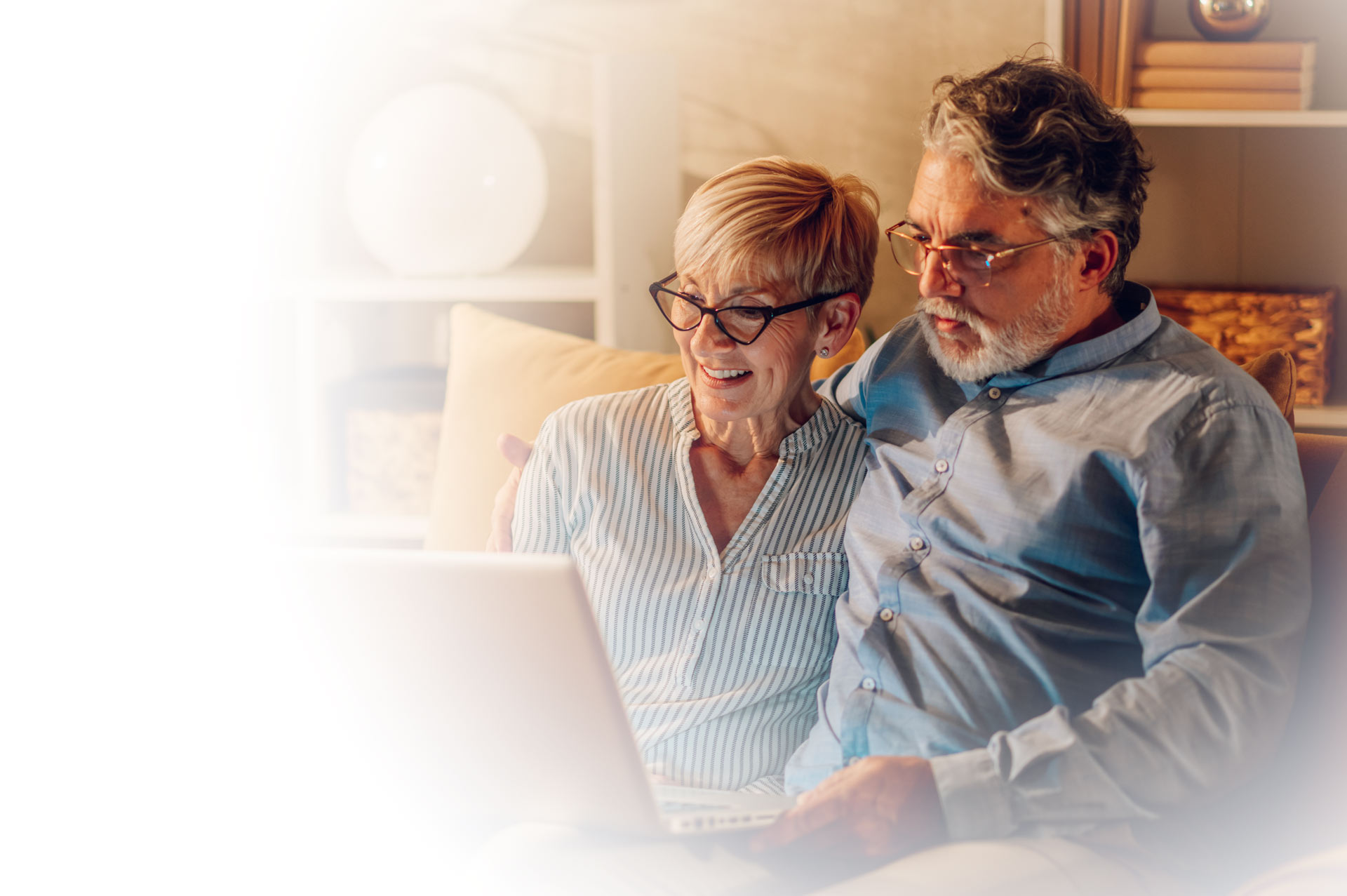 Senior couple checking bills on a laptop