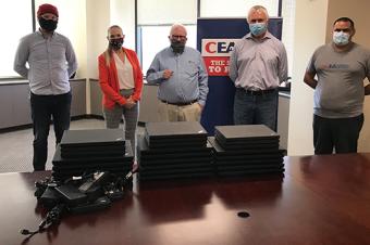 Image: The California Earthquake Authority (CEA) team donating laptops to members